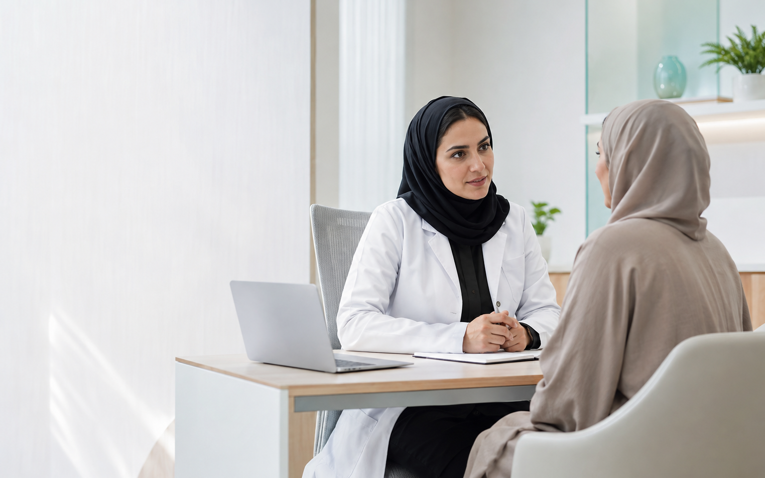 A clinician listening attentively to a patient in a contemporary clinic